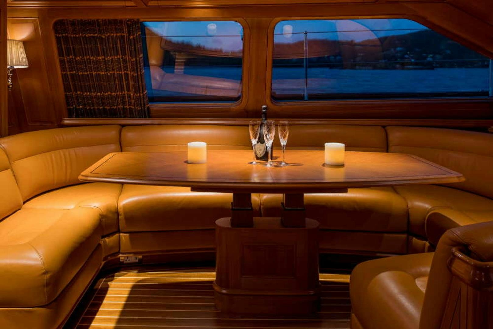 a table with wine glasses on it aboard BLUE TOO Yacht for Sale