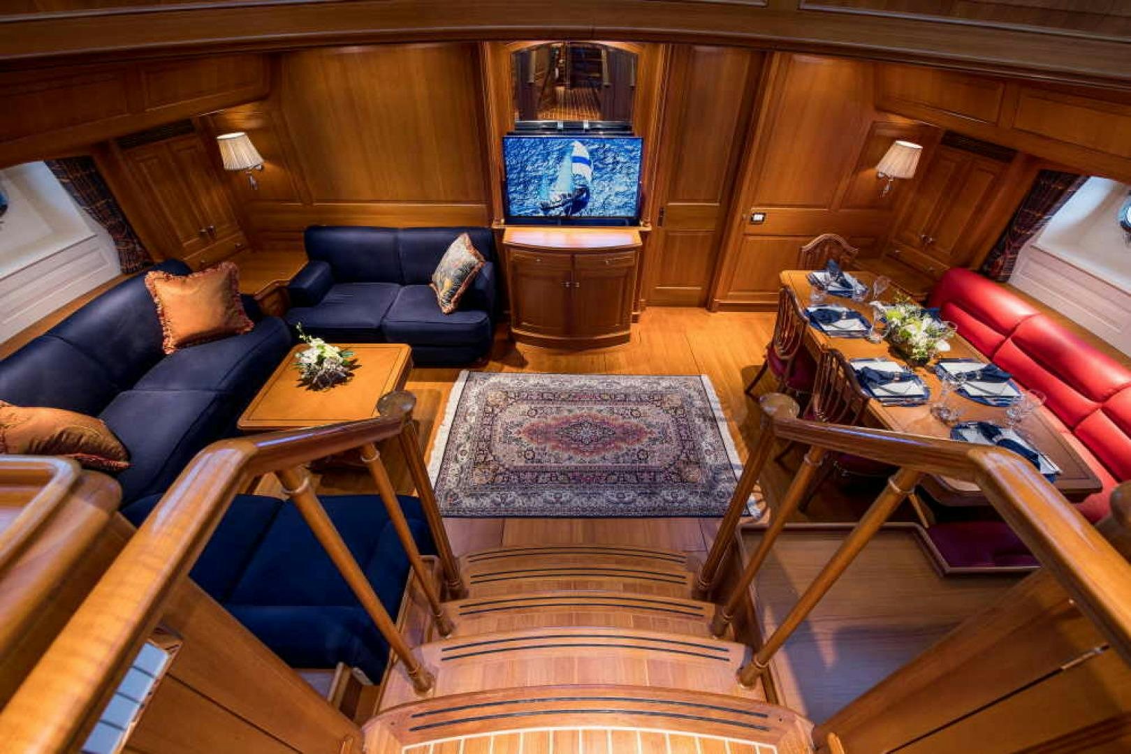 a living room with leather couches and a coffee table aboard BLUE TOO Yacht for Sale