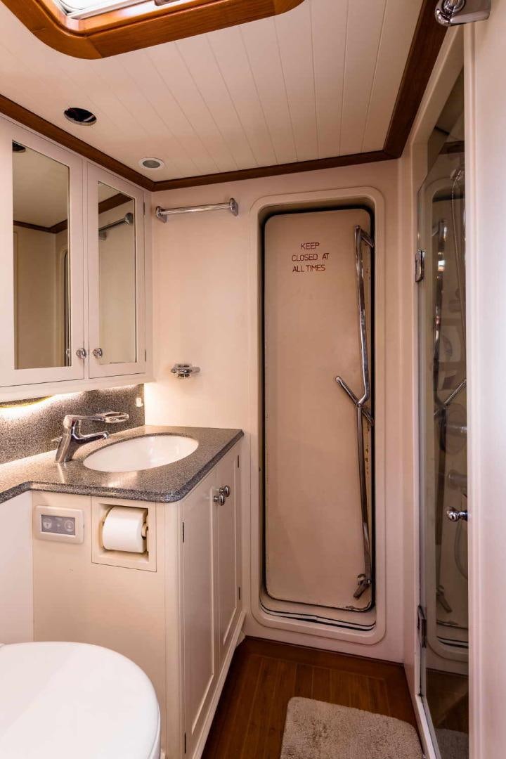 a bathroom with a sink and a shower unit aboard BLUE TOO Yacht for Sale