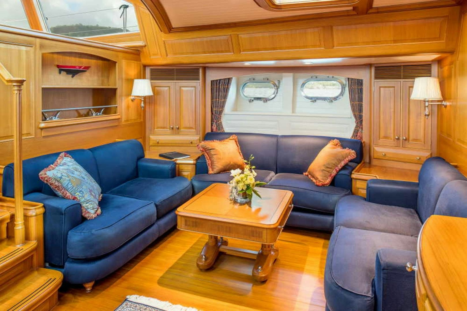 a living room with a blue couch aboard BLUE TOO Yacht for Sale