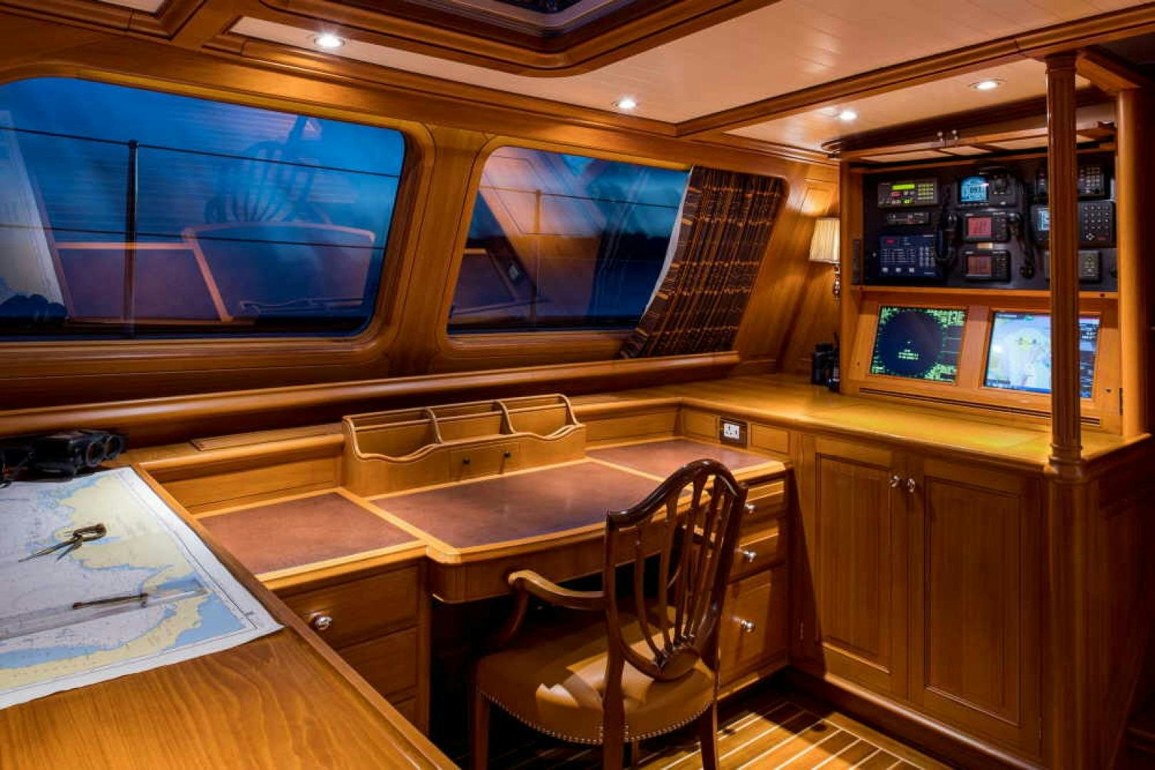 a room with a table and chairs aboard BLUE TOO Yacht for Sale