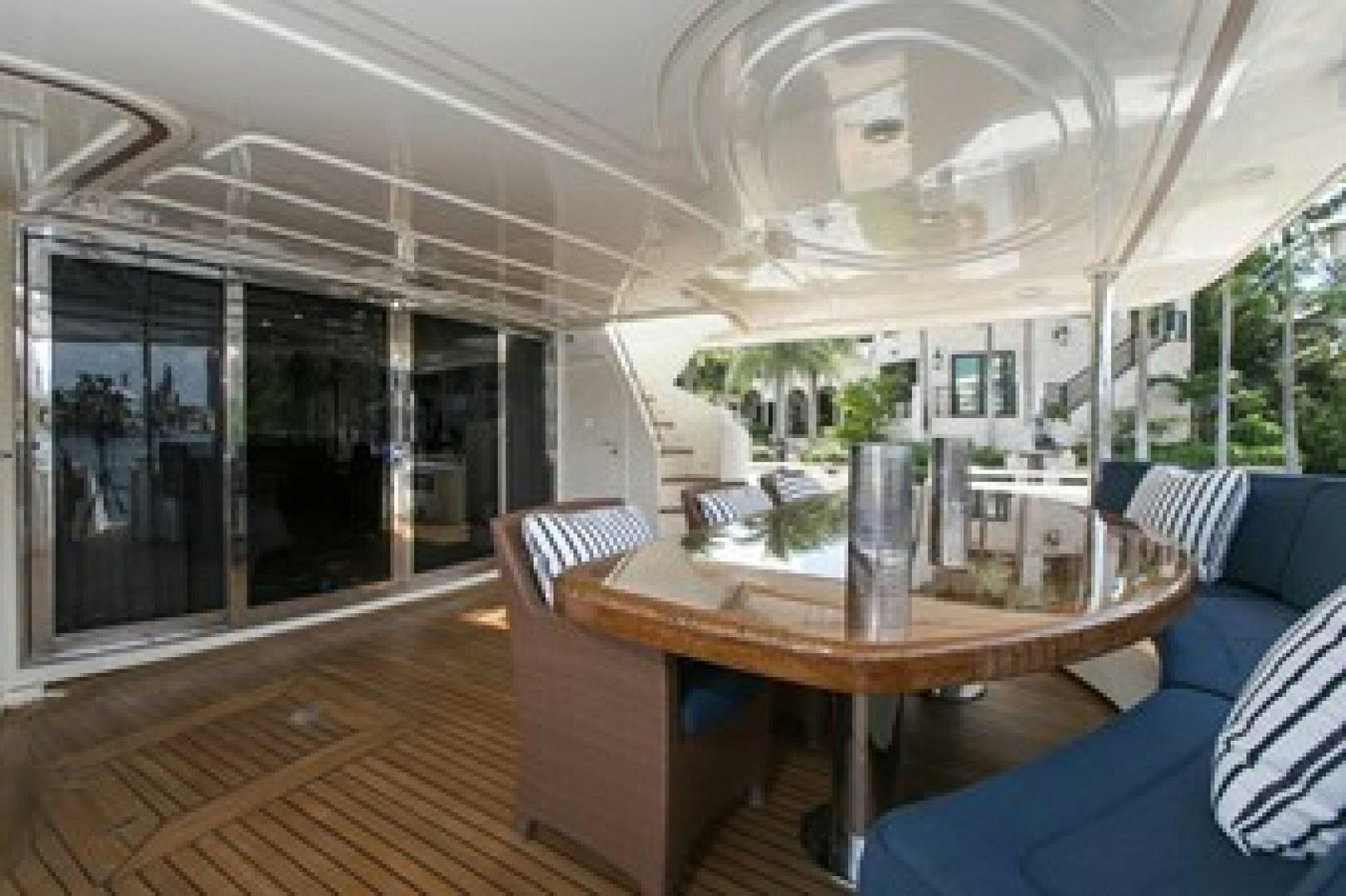 a large dining table in a room aboard MAMBO Yacht for Sale