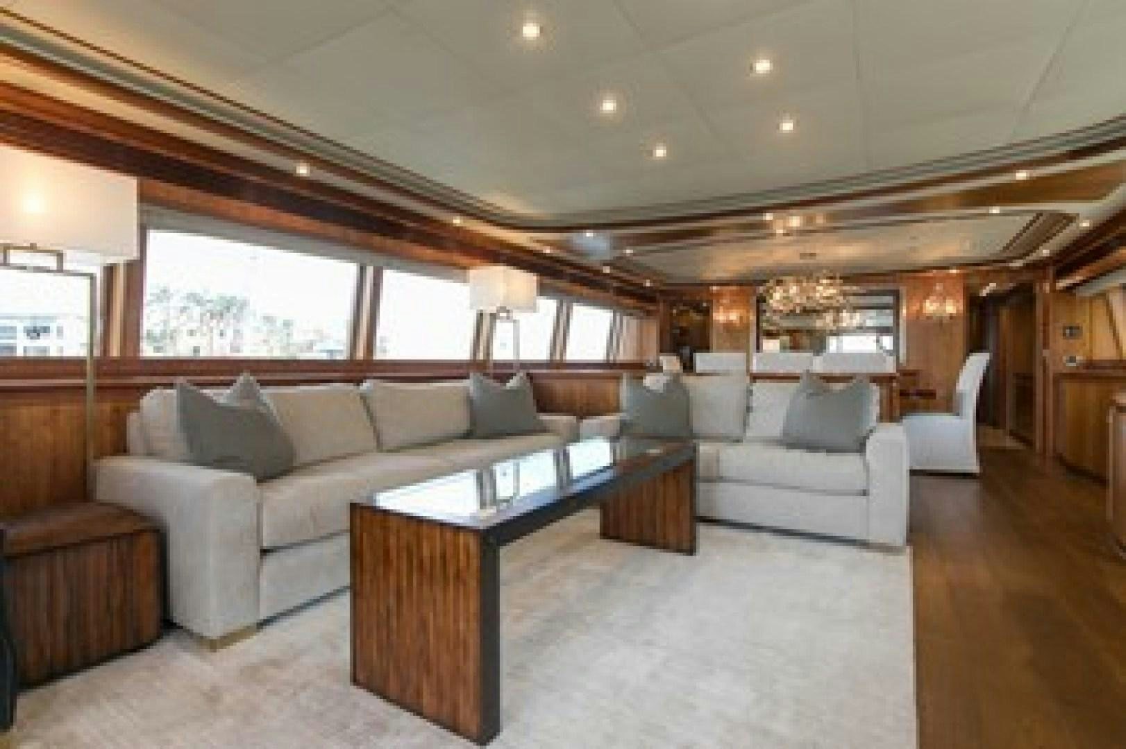 a living room with a couch and a coffee table aboard MAMBO Yacht for Sale