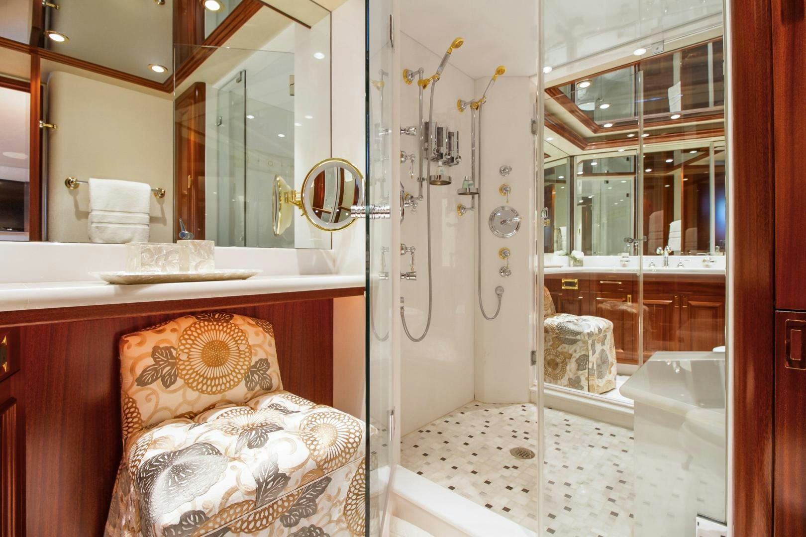 a bathroom with a chair and a shower aboard NAUTI N' Yacht for Sale