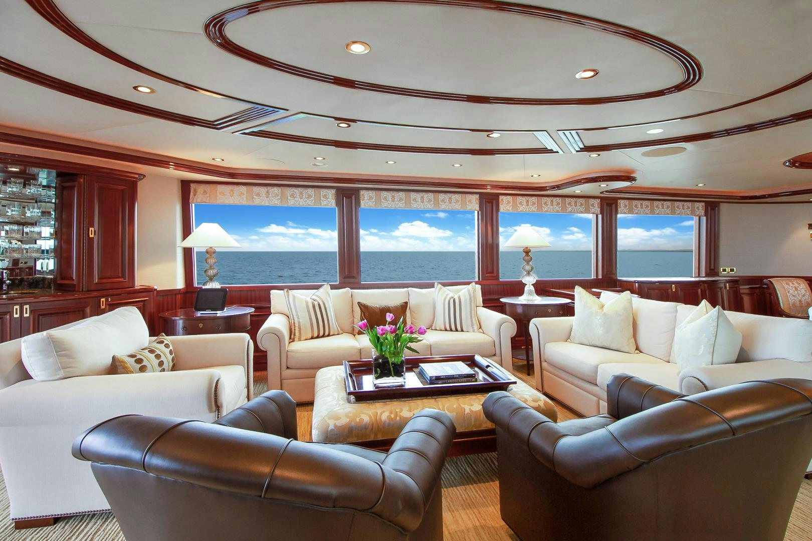 a living room with a large window aboard NAUTI N' Yacht for Sale