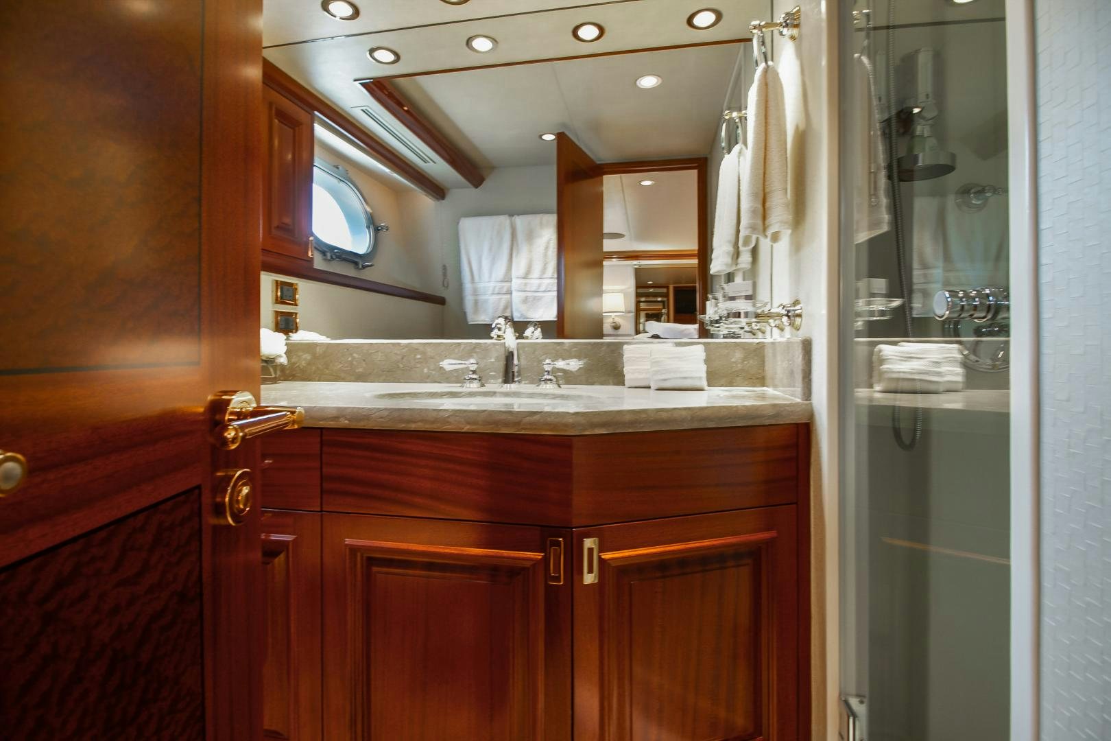 a bathroom with a sink and cabinets aboard NAUTI N' Yacht for Sale