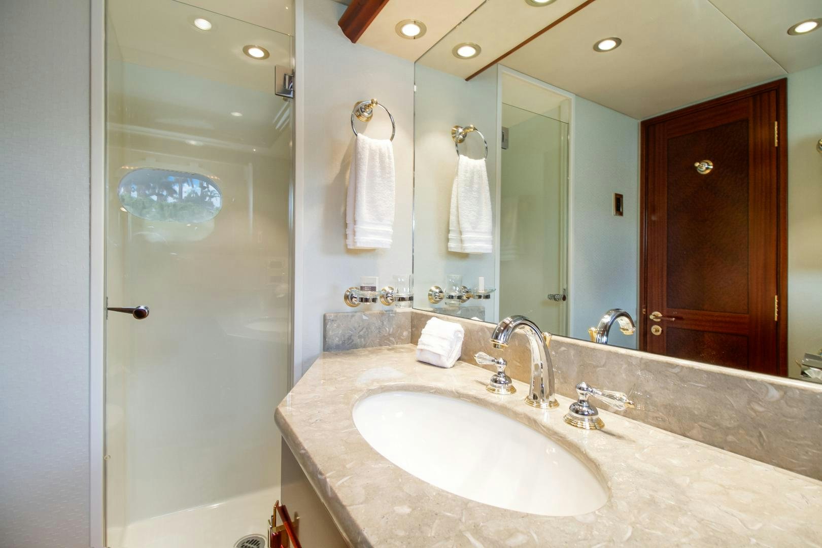 a bathroom with a large mirror aboard NAUTI N' Yacht for Sale