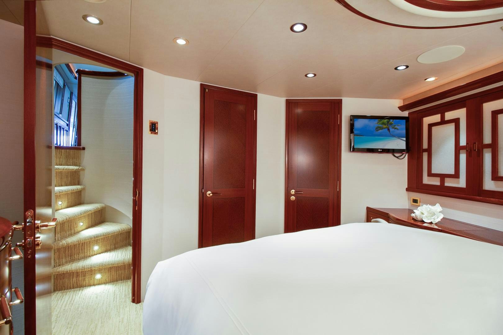 a hotel room with a bed and a television aboard NAUTI N' Yacht for Sale