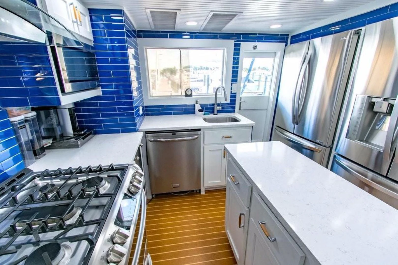 a kitchen with blue tile walls aboard TIMELESS Yacht for Sale