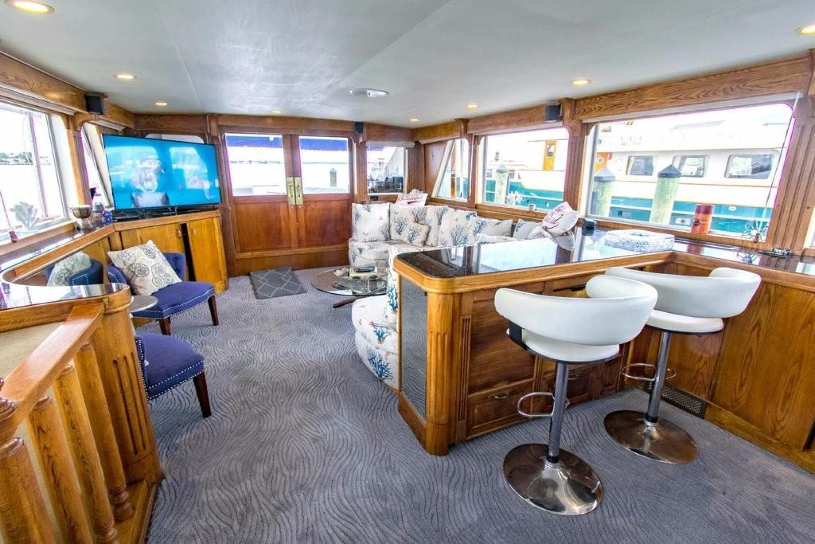 a large kitchen with a bar and bar stools aboard TIMELESS Yacht for Sale