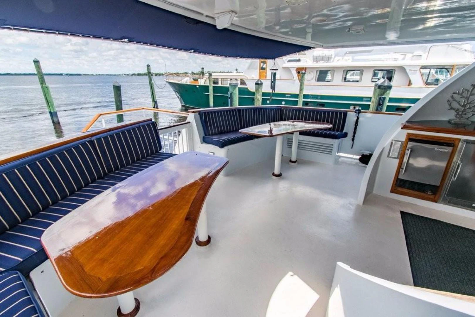 a boat with a table and chairs aboard TIMELESS Yacht for Sale