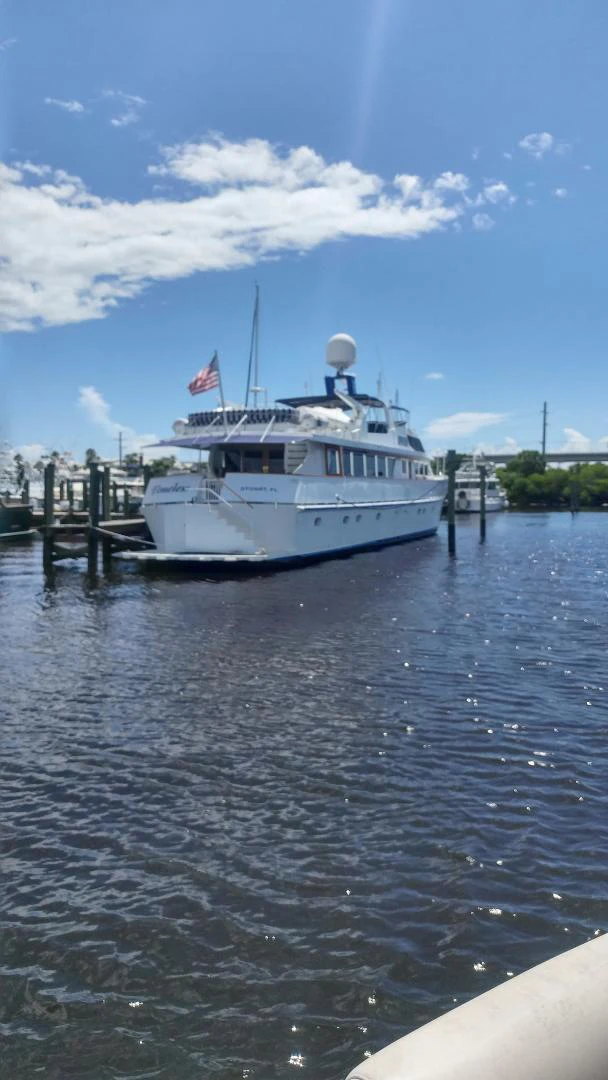 a boat docked at a pier aboard TIMELESS Yacht for Sale