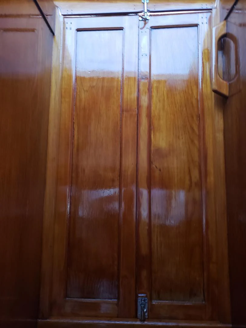 a wooden cabinet with a handle aboard TIMELESS Yacht for Sale