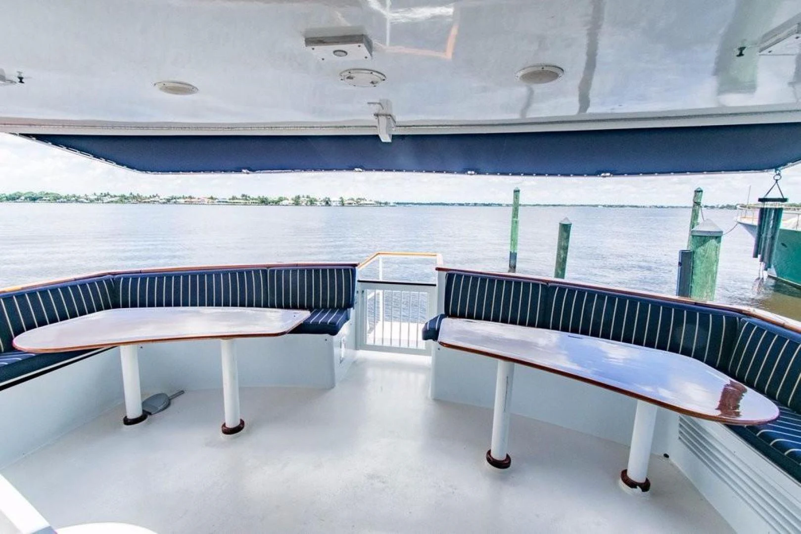 a row of benches next to a body of water aboard TIMELESS Yacht for Sale