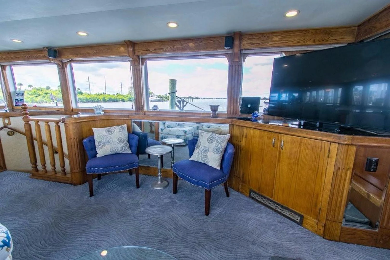 a kitchen with a bar and a couple chairs aboard TIMELESS Yacht for Sale