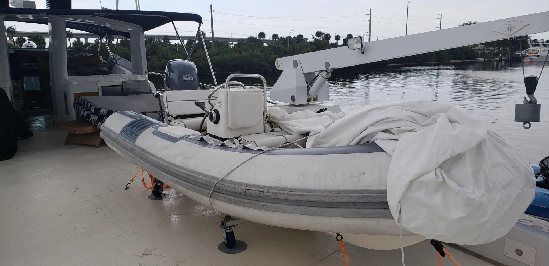 a white boat on a trailer aboard TIMELESS Yacht for Sale