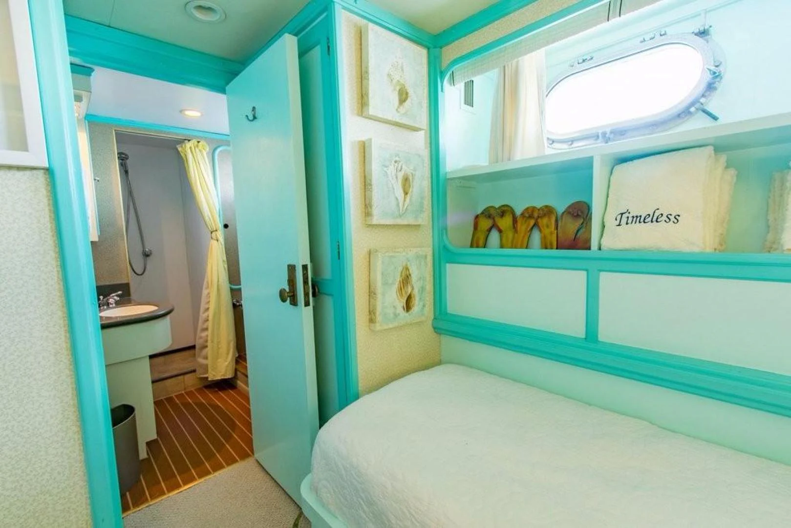 a bathroom with a blue door aboard TIMELESS Yacht for Sale