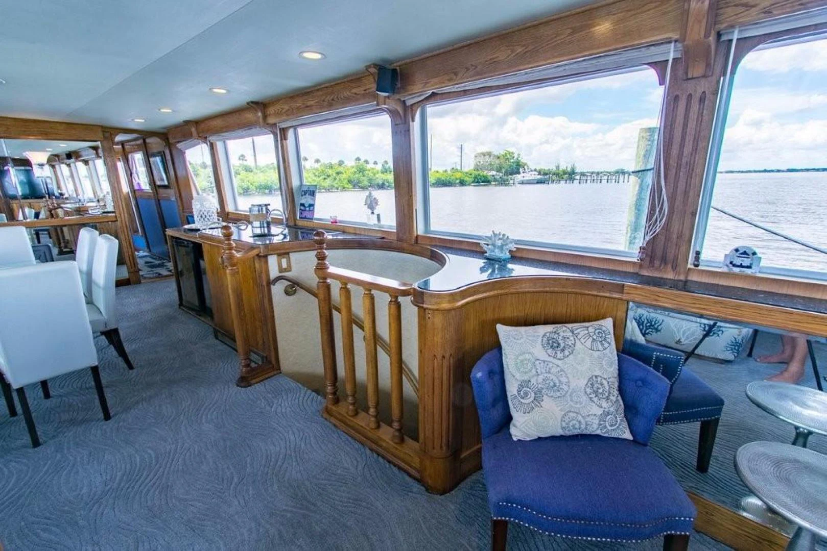a living room with a blue chair and a table aboard TIMELESS Yacht for Sale