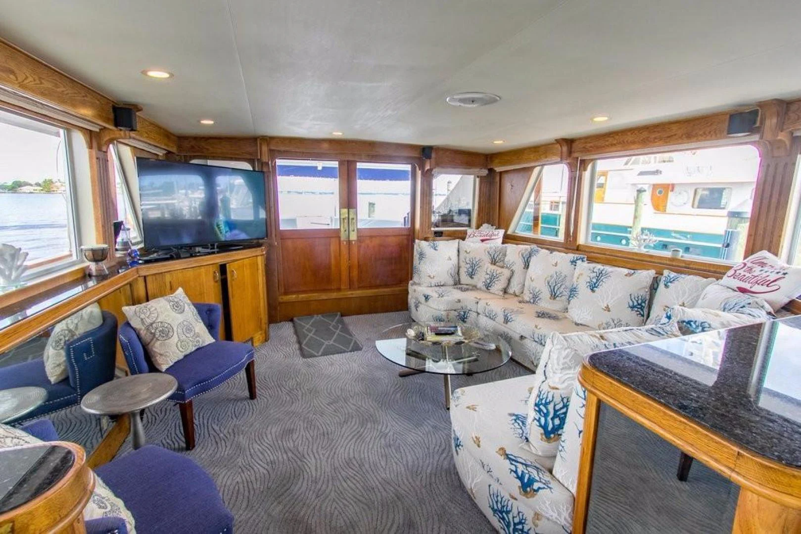 a living room with a couch and a television aboard TIMELESS Yacht for Sale
