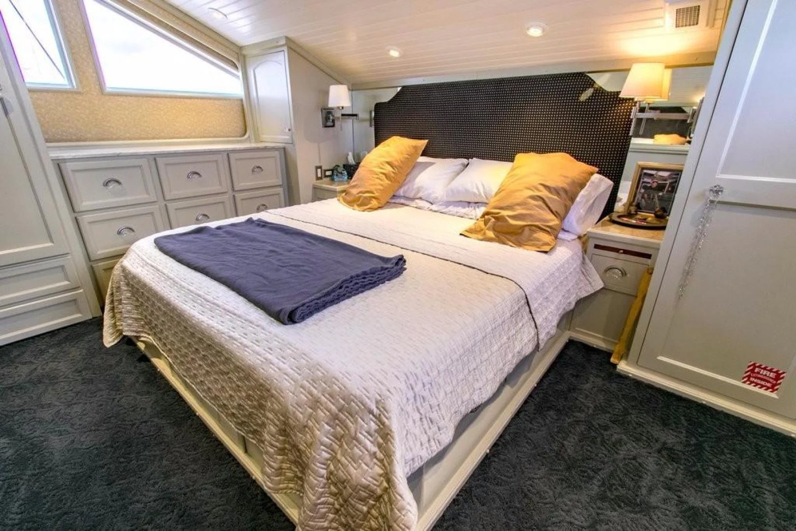 a bed with a white sheet and pillows aboard TIMELESS Yacht for Sale