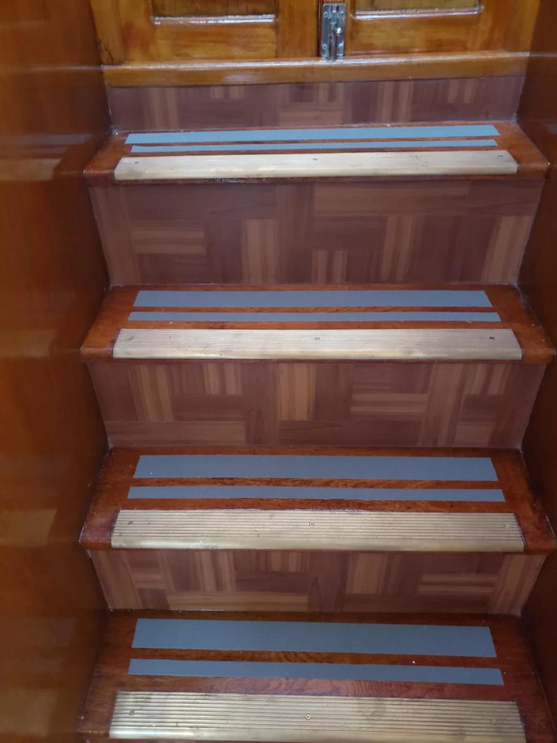 a group of books on a shelf aboard TIMELESS Yacht for Sale