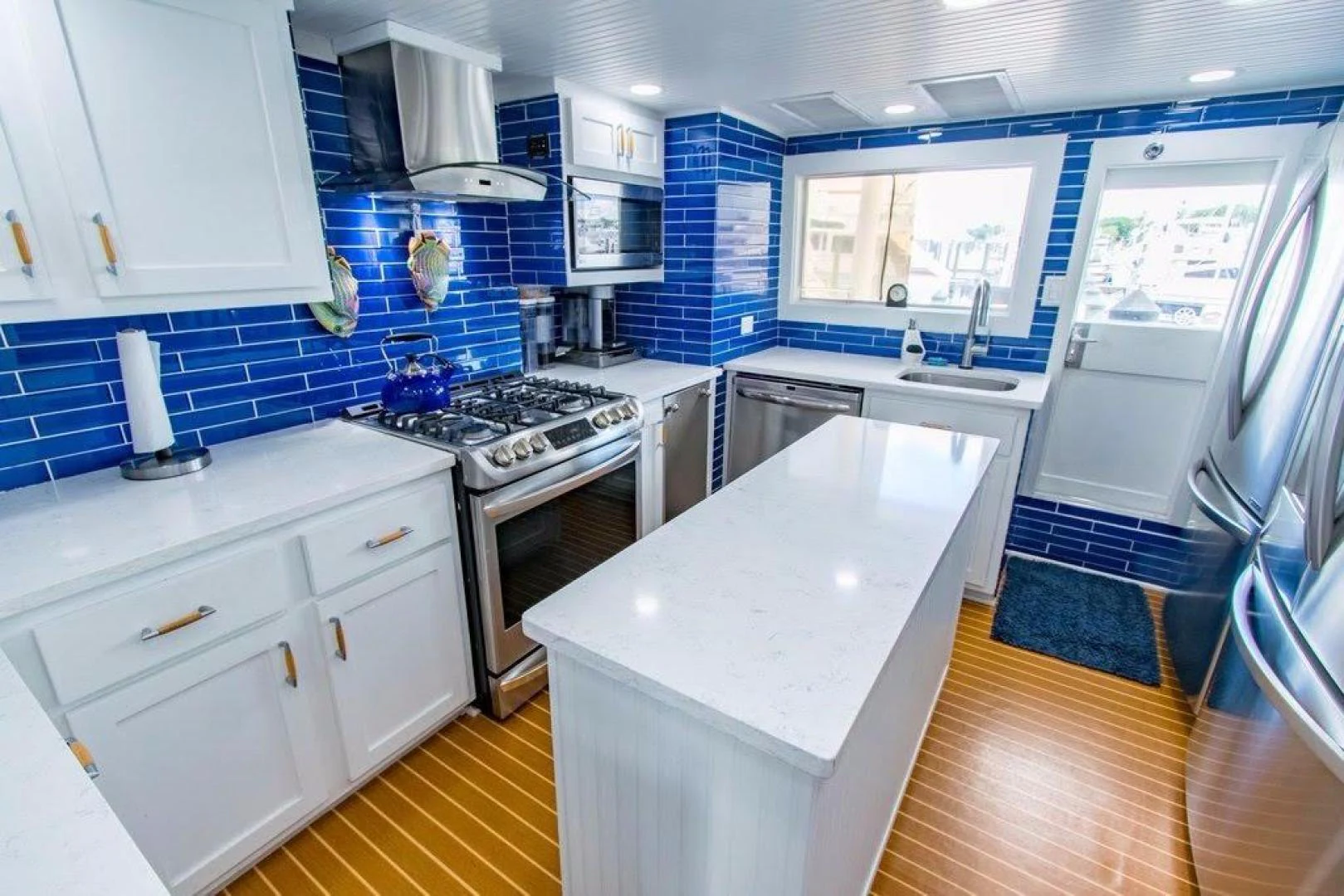 a kitchen with white cabinets aboard TIMELESS Yacht for Sale