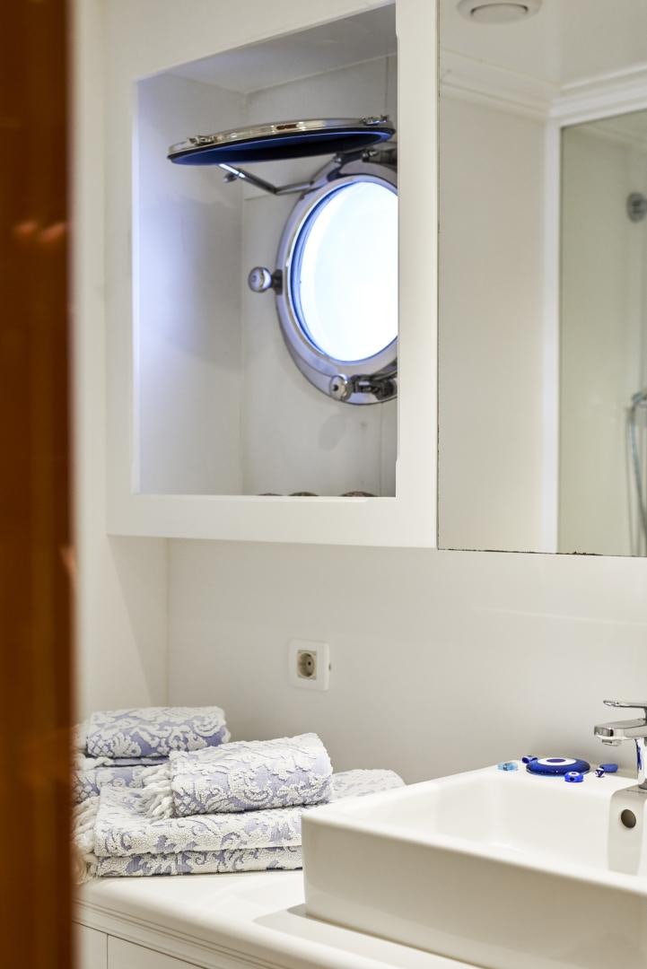 a bathroom with a mirror and a bed aboard OLDE SALT Yacht for Sale