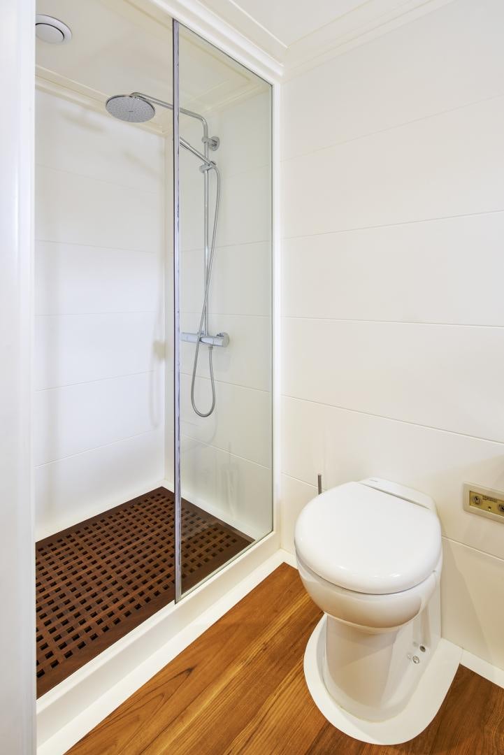 a bathroom with a shower unit and a toilet aboard OLDE SALT Yacht for Sale