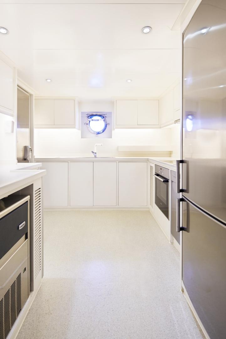 a kitchen with white cabinets aboard OLDE SALT Yacht for Sale