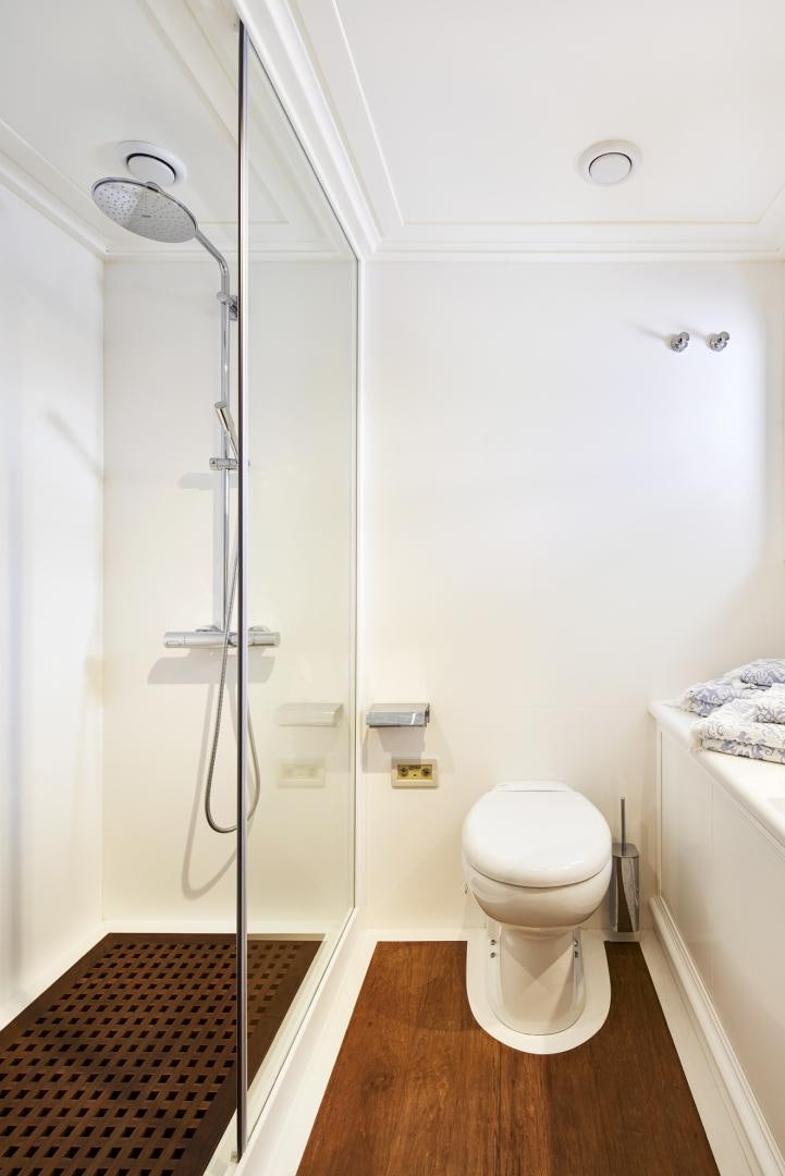 a bathroom with a shower unit and toilet aboard OLDE SALT Yacht for Sale