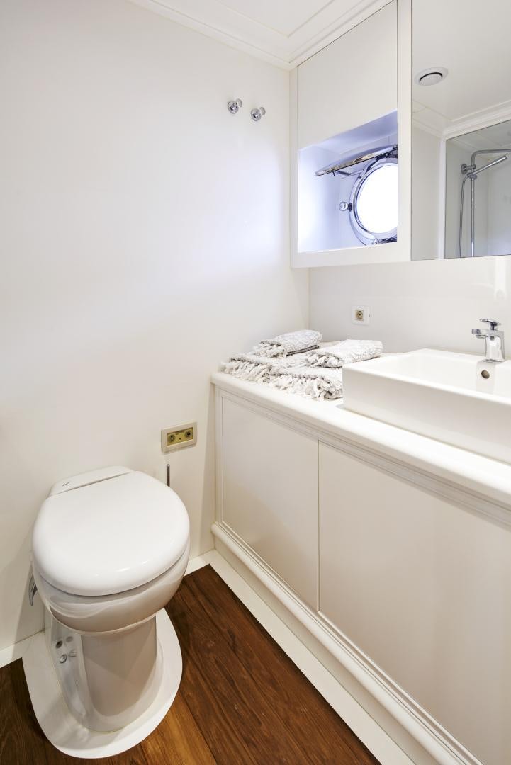 a bathroom with a toilet and a sink aboard OLDE SALT Yacht for Sale
