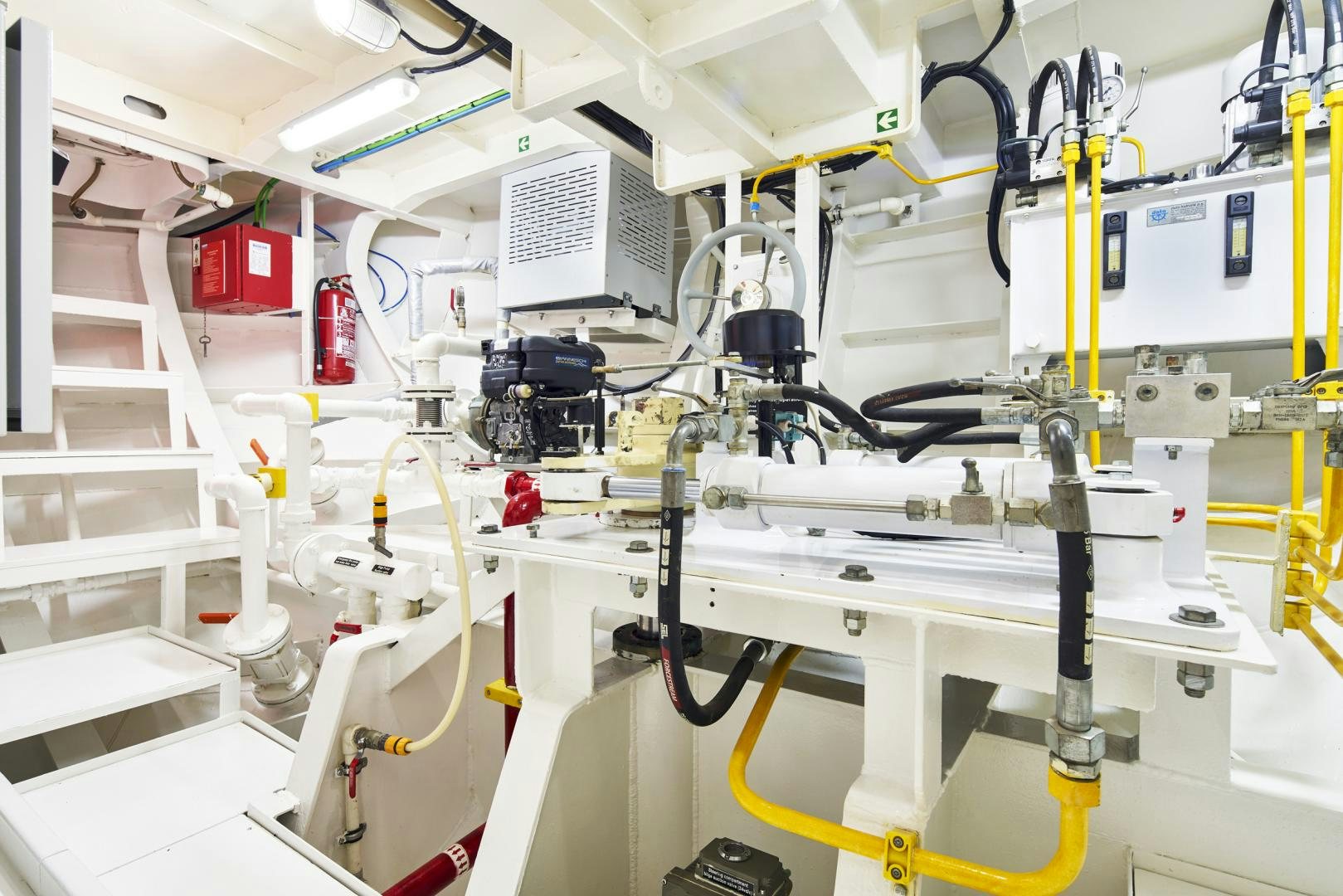 a room with white shelves and yellow and red machinery aboard OLDE SALT Yacht for Sale