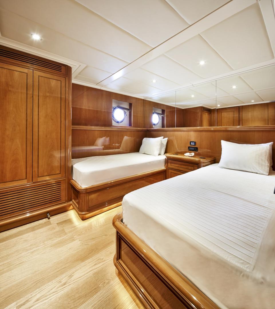 a room with a bed and a wood cabinet aboard OLDE SALT Yacht for Sale