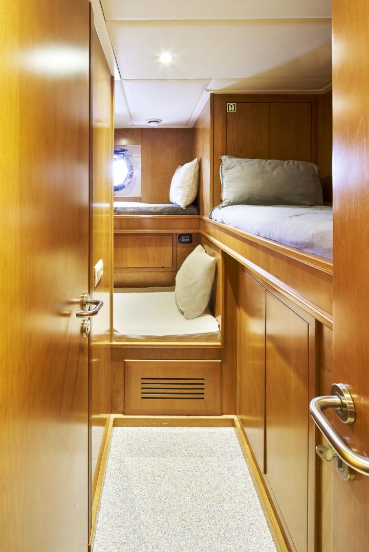 a small room with a bed and a closet aboard OLDE SALT Yacht for Sale