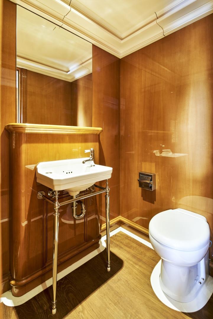 a bathroom with a toilet sink and a mirror aboard OLDE SALT Yacht for Sale