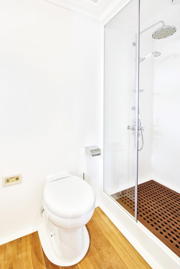 a bathroom with a toilet and shower aboard OLDE SALT Yacht for Sale