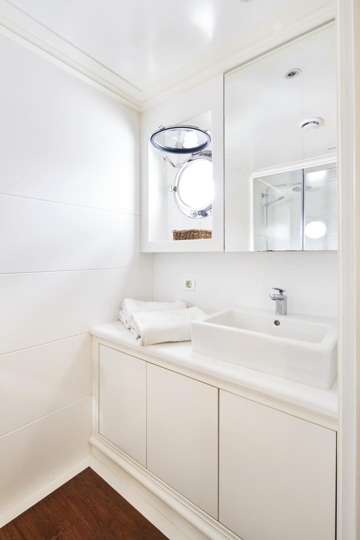 a bathroom with a sink and a mirror aboard OLDE SALT Yacht for Sale