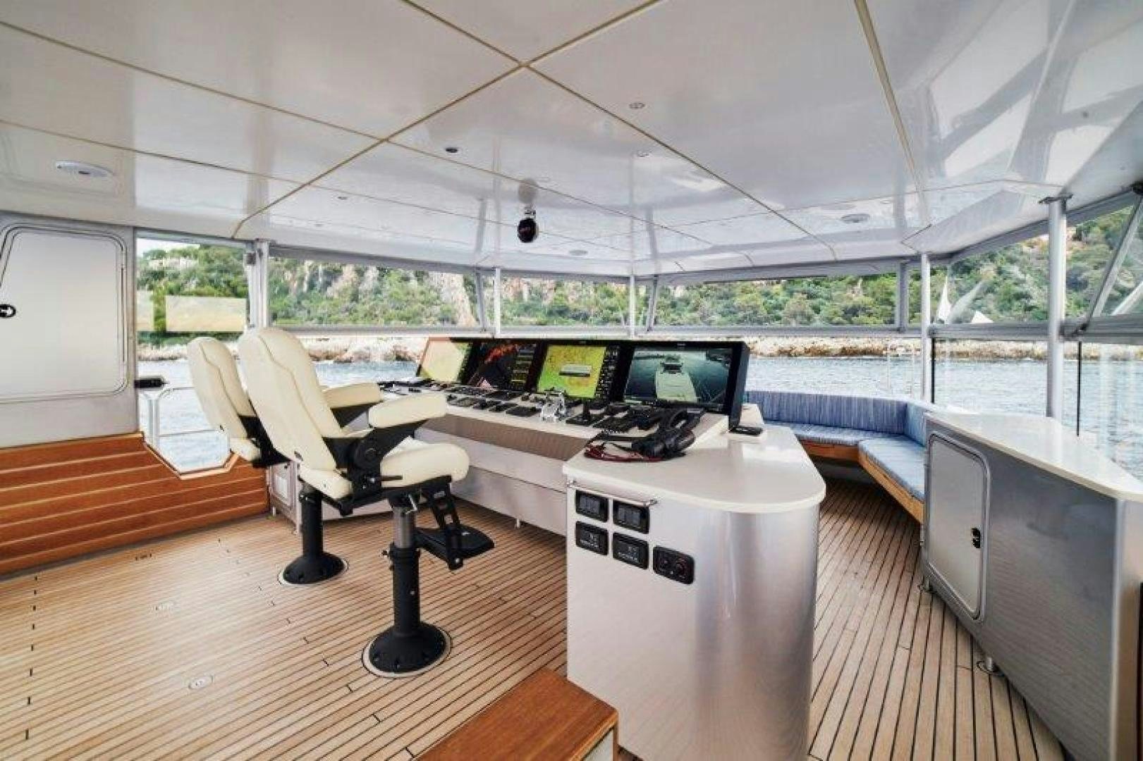 a room with a table and chairs aboard ICEBERG Yacht for Sale