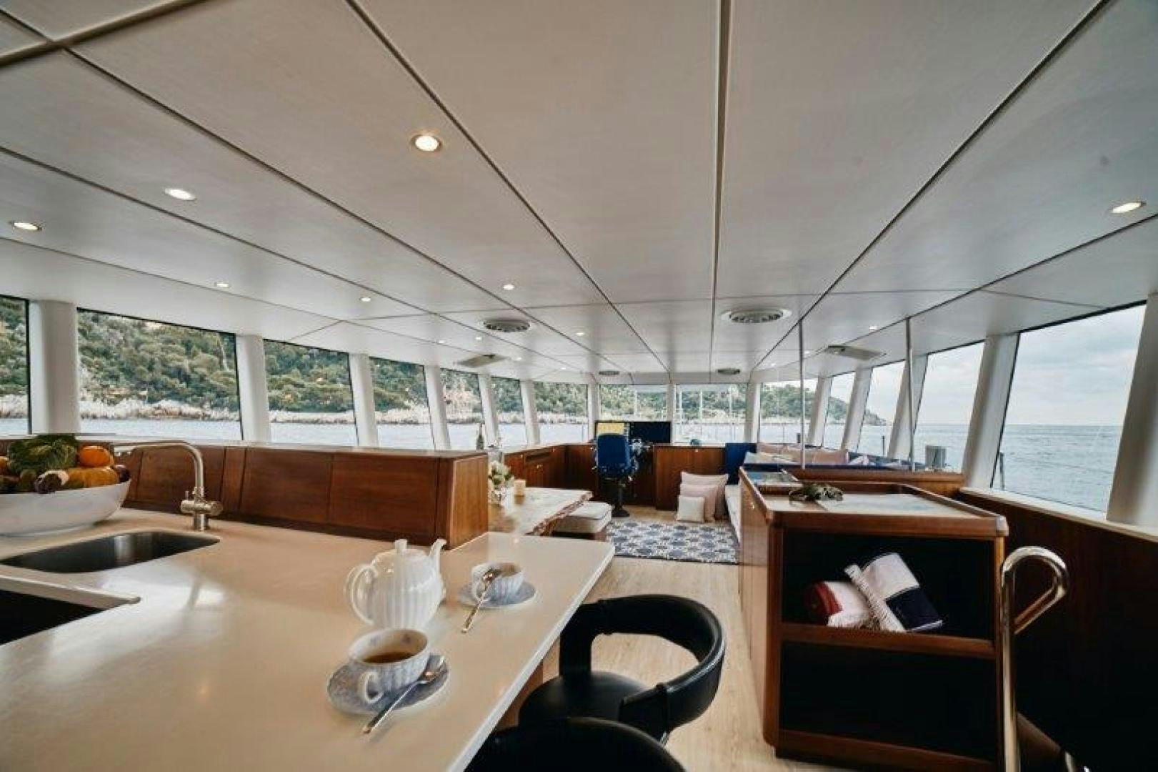 a large room with a table and chairs aboard ICEBERG Yacht for Sale