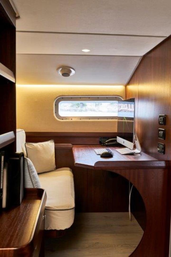a desk with a computer and a chair aboard ICEBERG Yacht for Sale