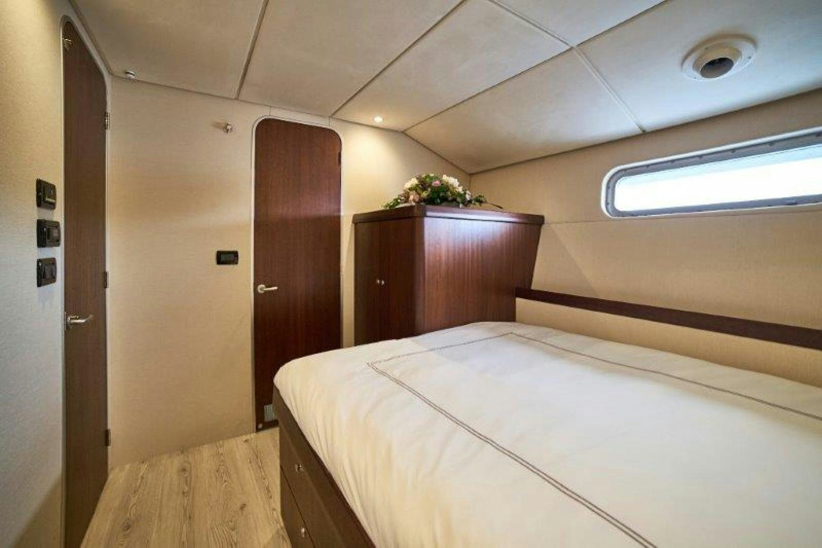 a room with a bed and a door aboard ICEBERG Yacht for Sale