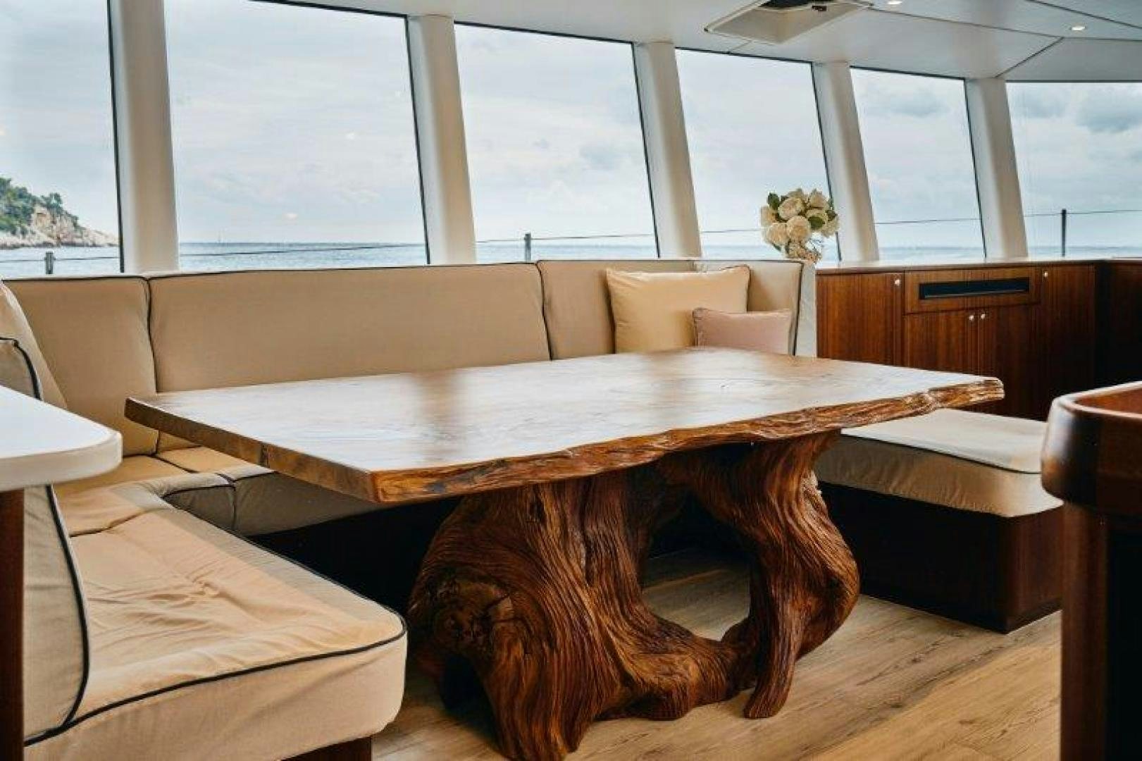 a couch and a table in a room with windows aboard ICEBERG Yacht for Sale