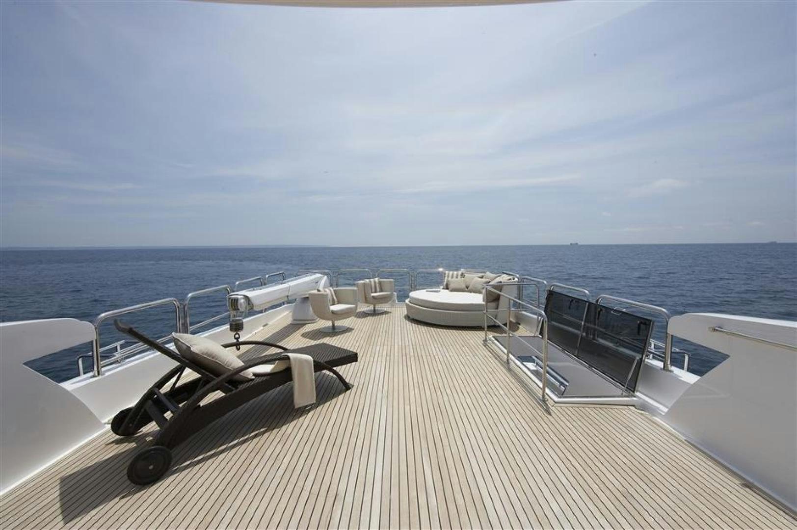 a deck with chairs and tables on it aboard JOHNSON 110 SKYLOUNGE Yacht for Sale