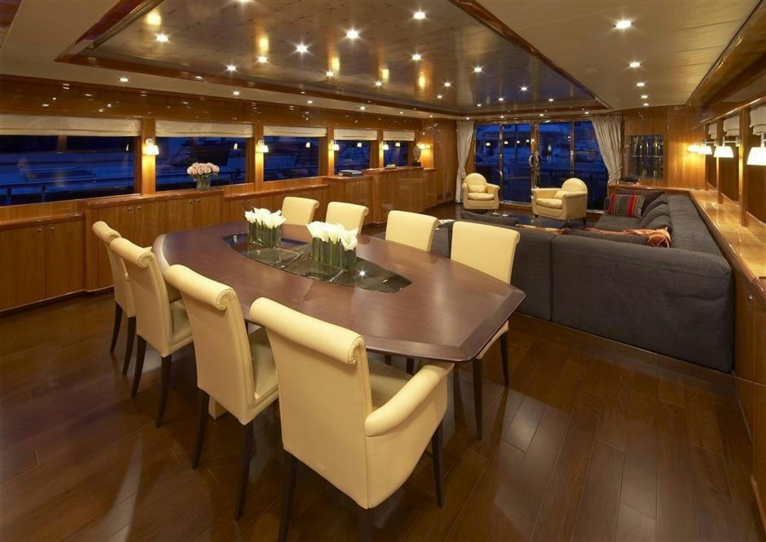 a room with a table and chairs aboard JOHNSON 110 FLYBRIDGE Yacht for Charter