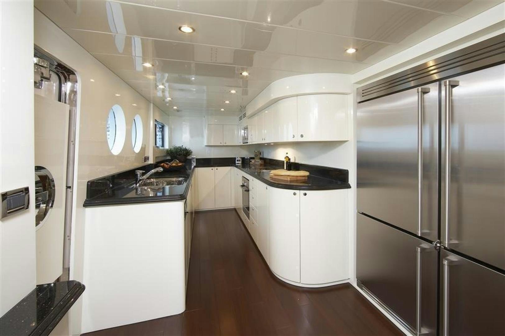 a kitchen with white cabinets aboard JOHNSON 110 FLYBRIDGE Yacht for Charter
