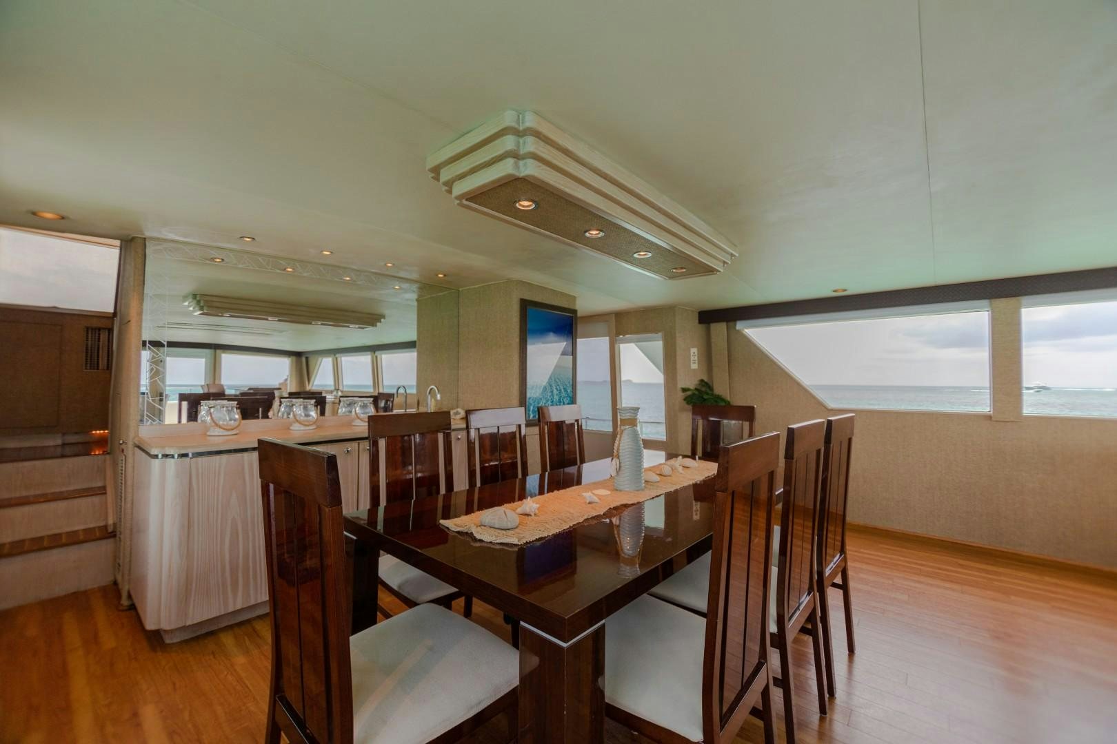 a large kitchen with a table and chairs aboard ISLAND TIME Yacht for Sale