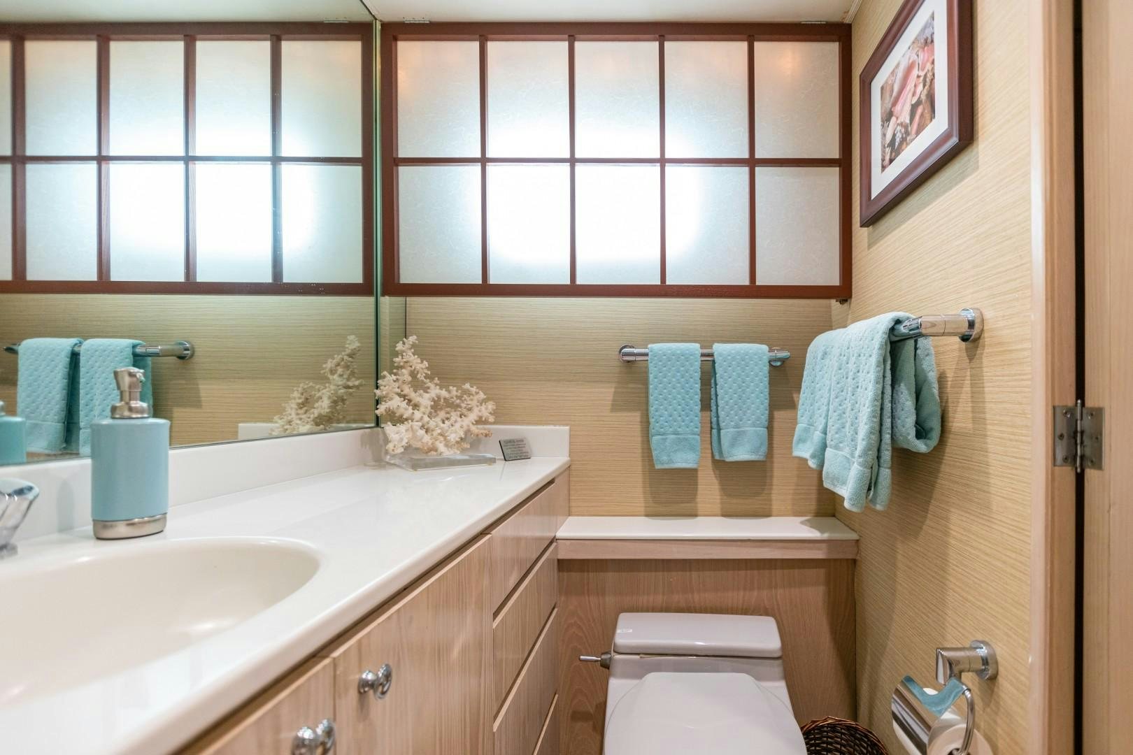 a bathroom with a sink and toilet aboard ISLAND TIME Yacht for Sale
