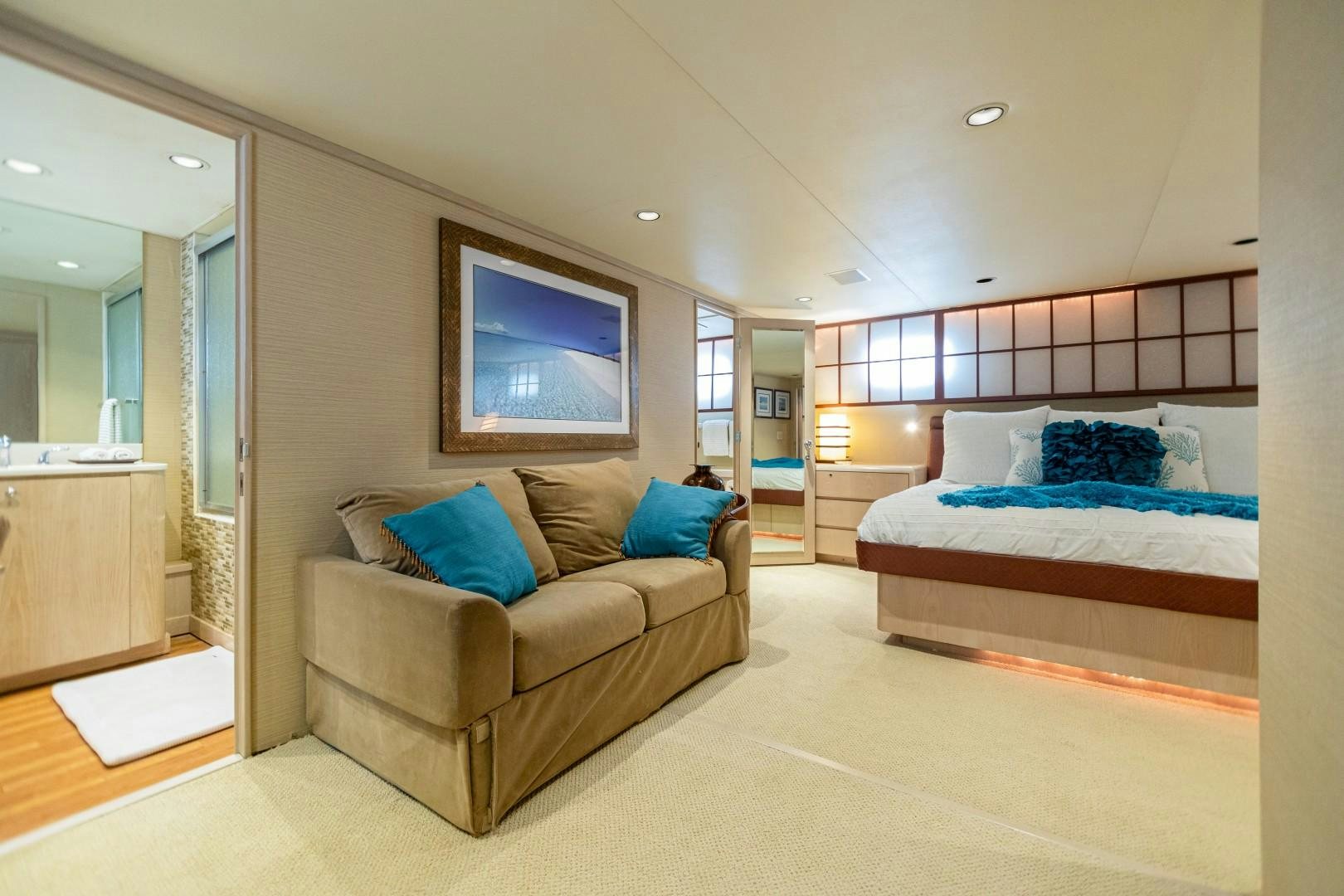 a bedroom with a bed and a couch aboard ISLAND TIME Yacht for Sale