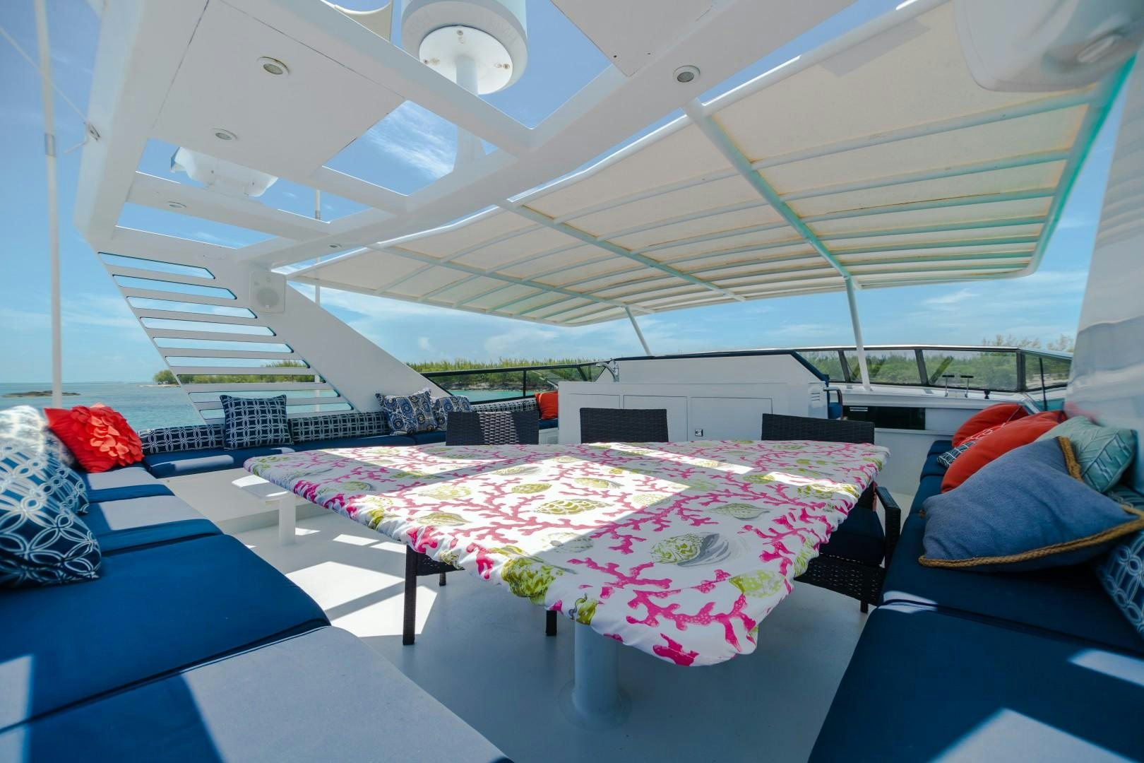 a room with a table and a bed aboard ISLAND TIME Yacht for Sale