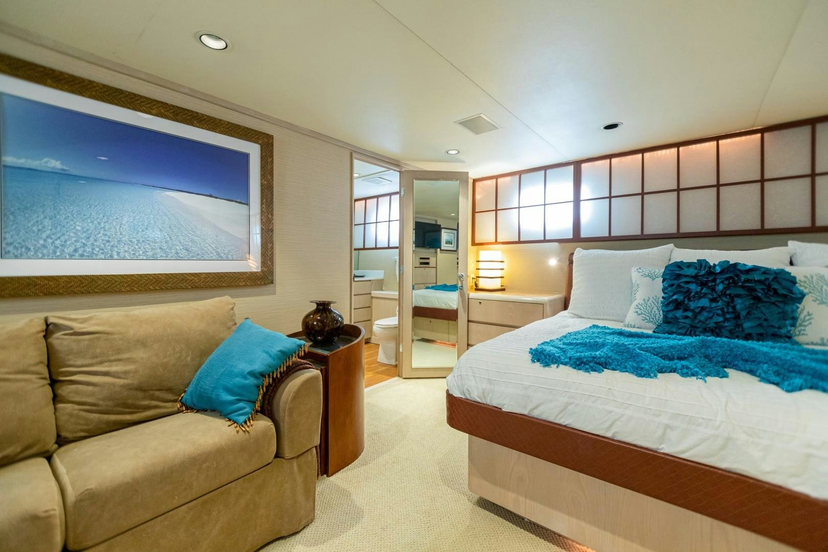 a bedroom with a bed and a couch aboard ISLAND TIME Yacht for Sale